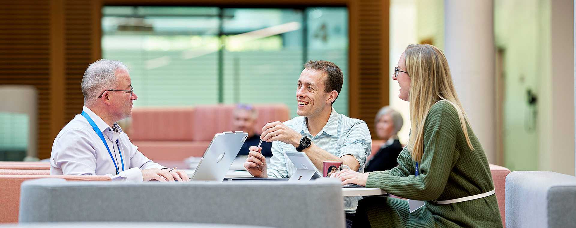 People meeting around a desk.