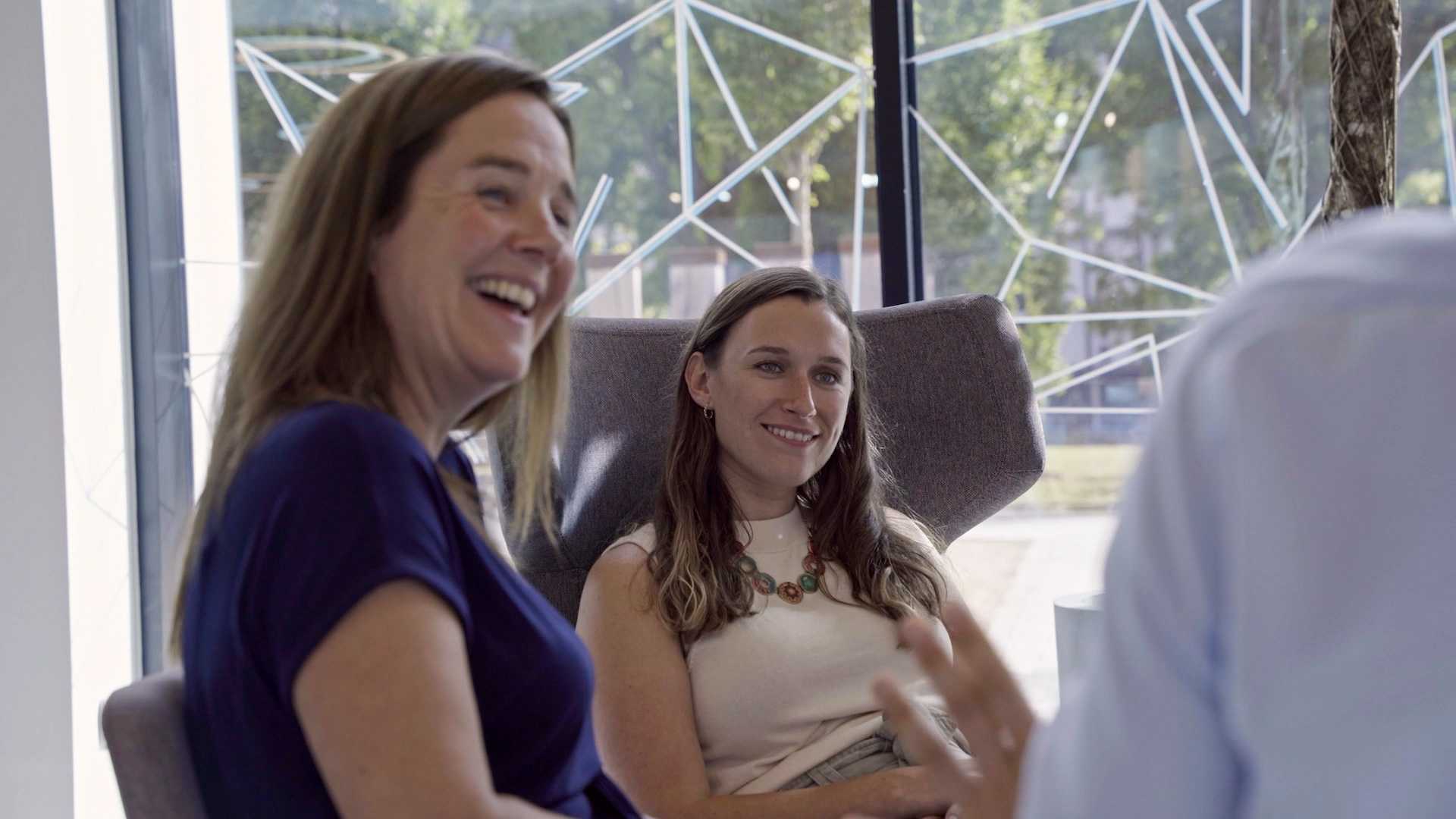 Three people enjoying a meeting.